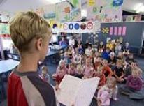 Student reading from workbook. 